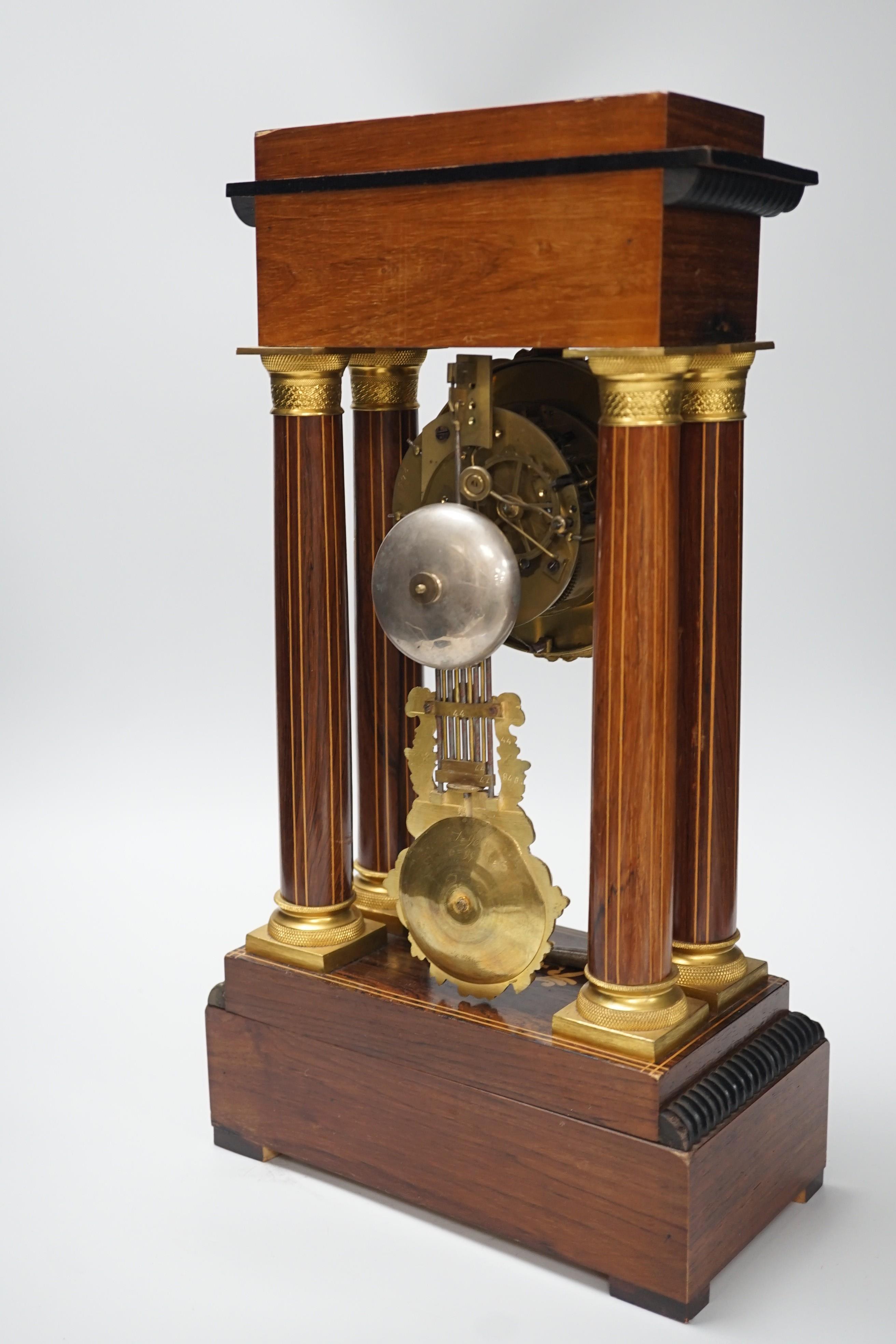 A late 19th century rosewood and marquetry portico clock with ormolu mounts